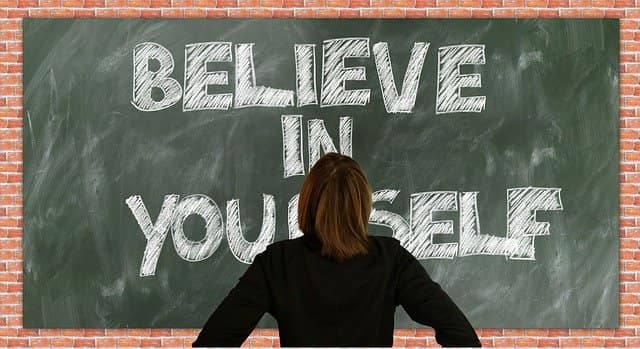 Believe in yourself Woman facing a chalkboard that reads Believe in Yourself
