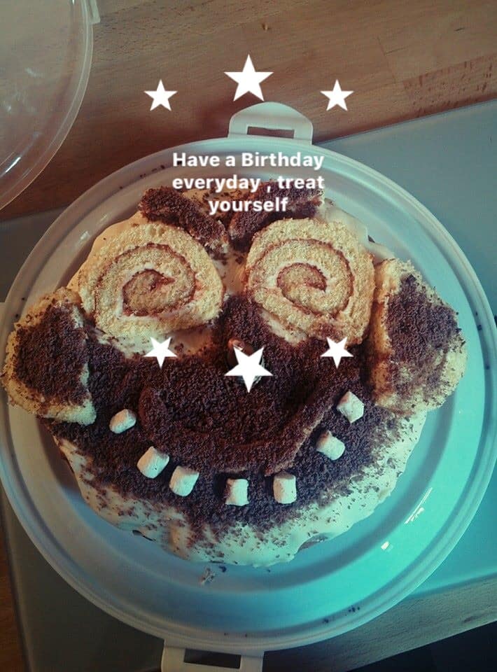 Swiss roll cake decorated with a smiley face