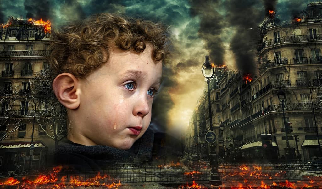 Trauma and PTSD Child with tears in front of a burning city