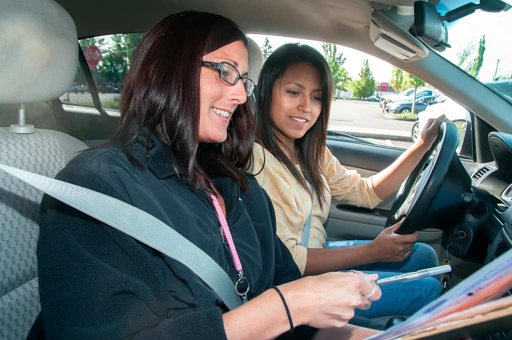 Driving test nerves Smiling learner driver and passenger in a car