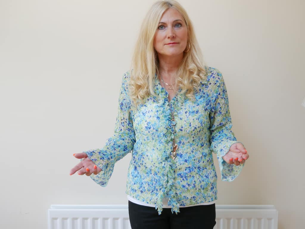 Sonya Hudson standing with open hands as she speaks