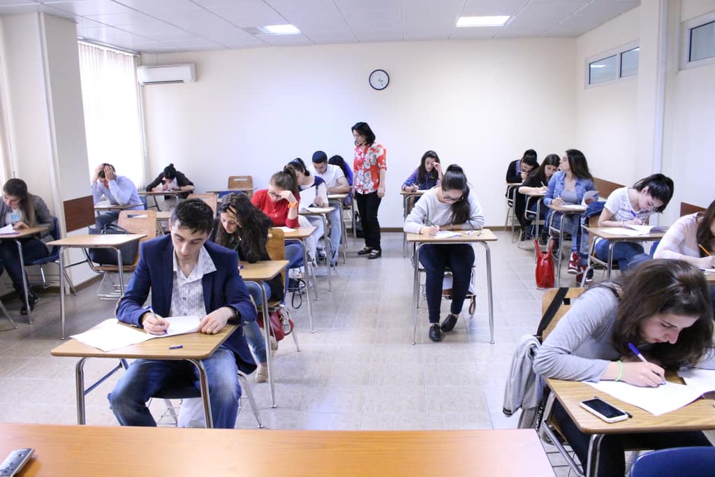 Exam nerves Students sitting a written exam in a classroom