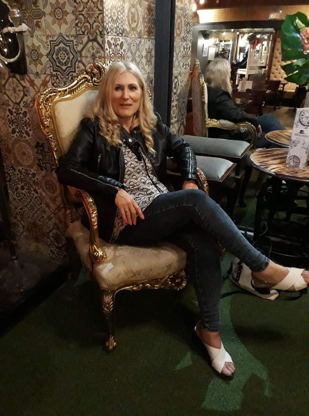 Taking time for yourself Woman sitting in an ornate gold armchair