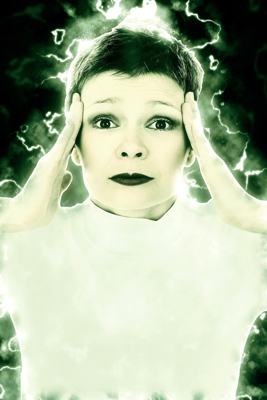 Woman holding her head with glowing energy around her