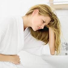 Menstrual discomfort Young woman holding her stomach in discomfort
